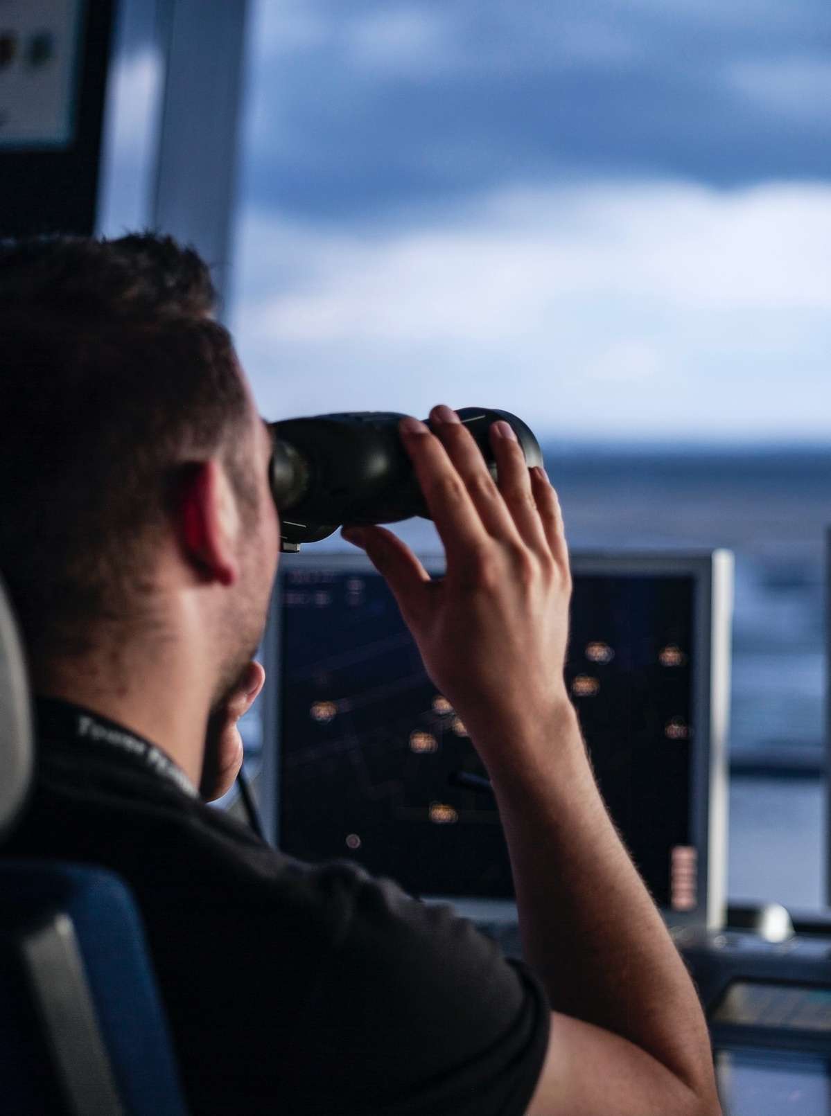 air traffic controller using binoculars