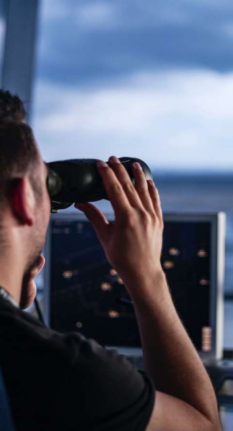air traffic controller using binoculars